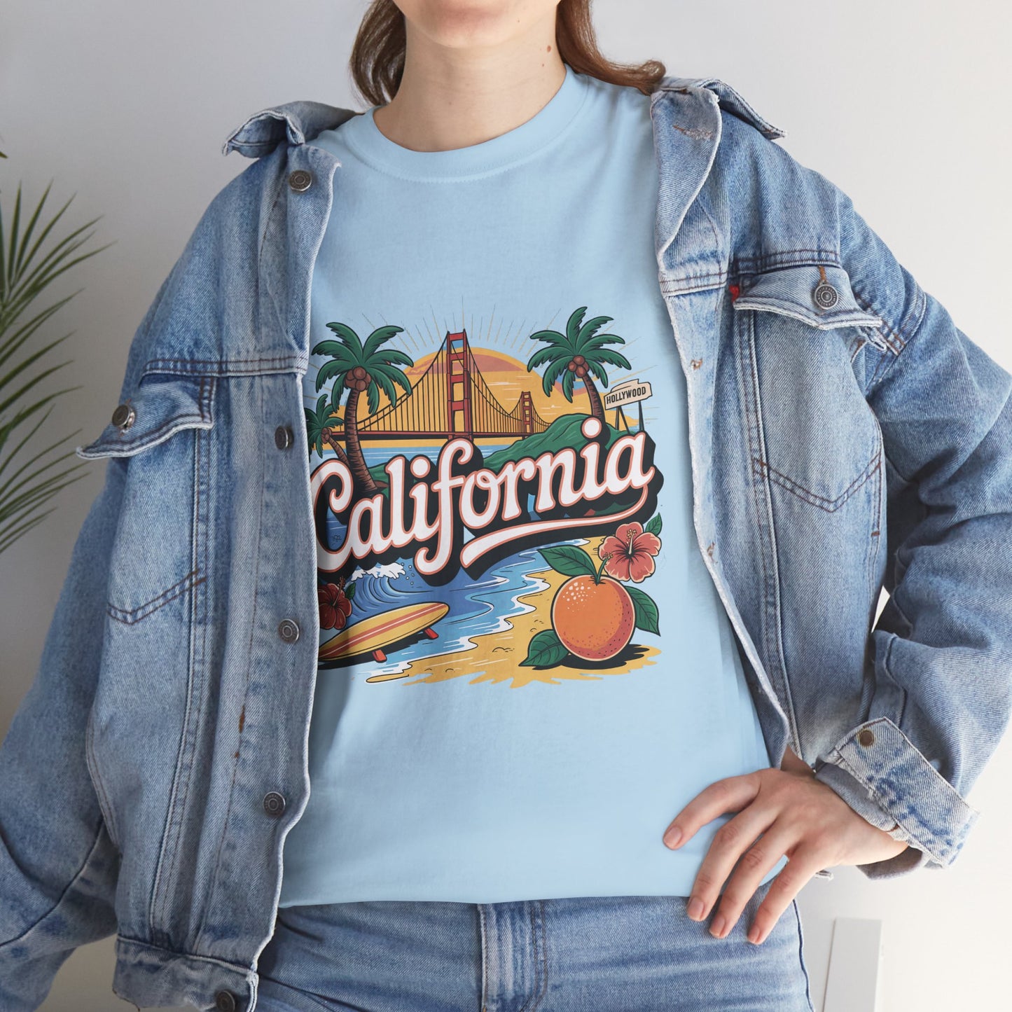 Person wearing a light blue t-shirt with 'California' graphic design, paired with a denim jacket.