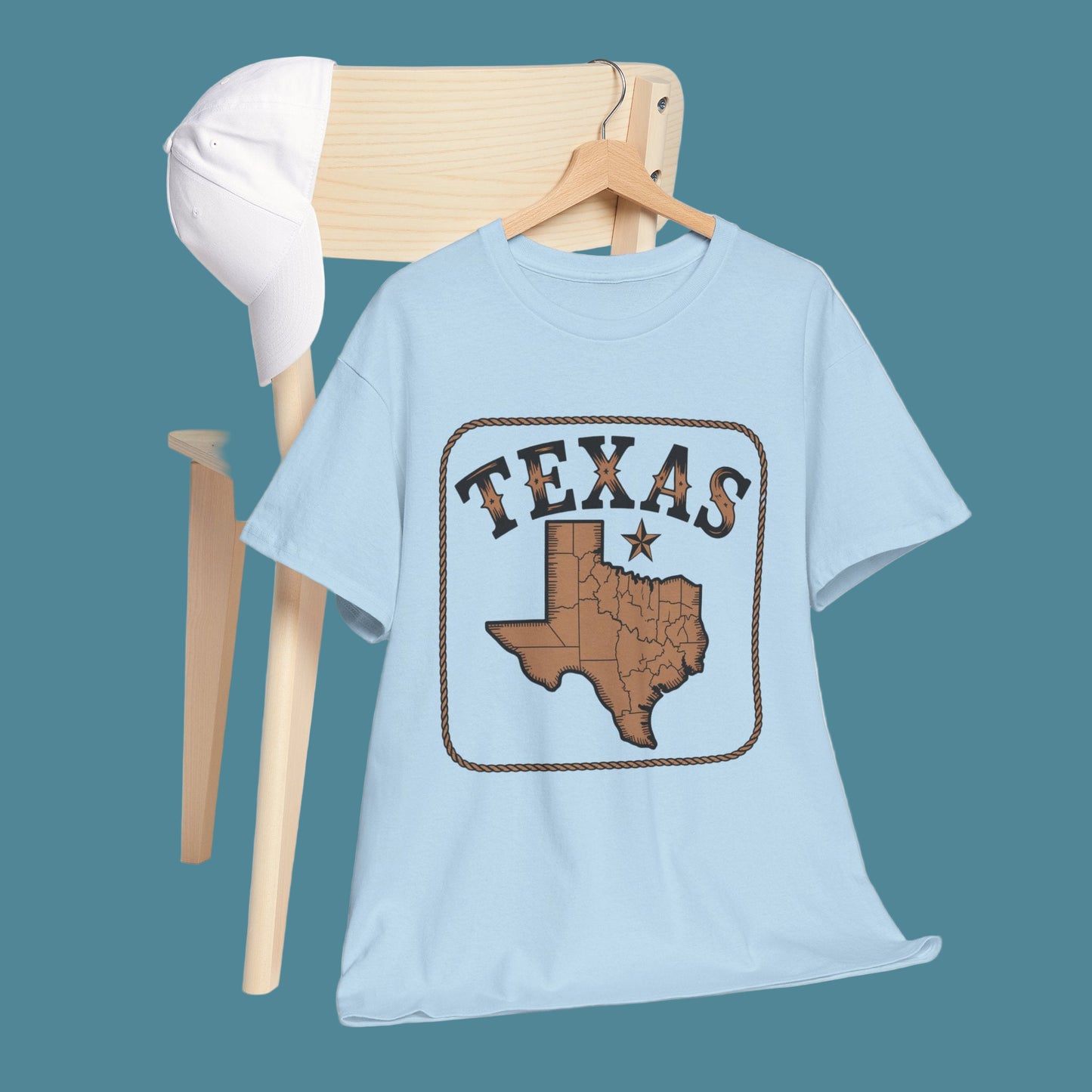 Light blue t-shirt with Texas design on a wooden chair against a white background