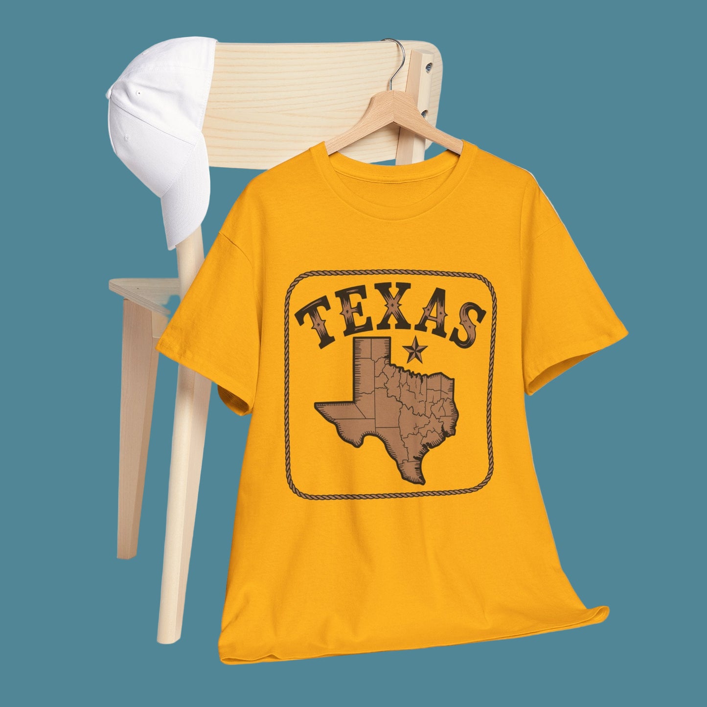 Yellow t-shirt with Texas design on a wooden hanger against a white background