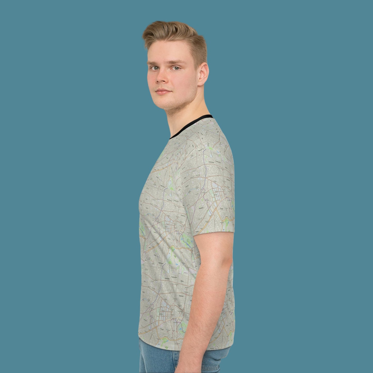 Man wearing a light gray t-shirt with a subtle pattern on a white background