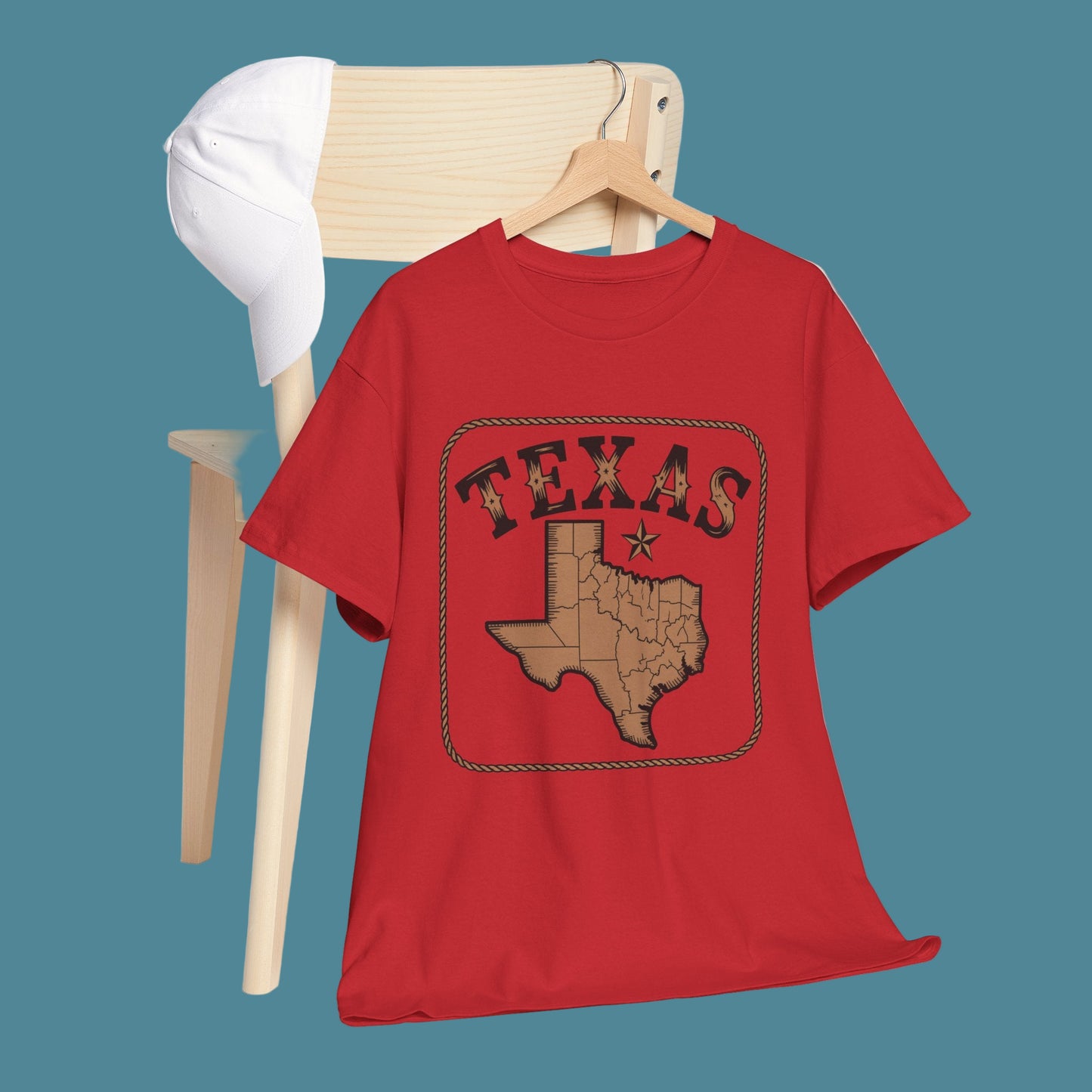 Red t-shirt with Texas design on a wooden chair against a white background