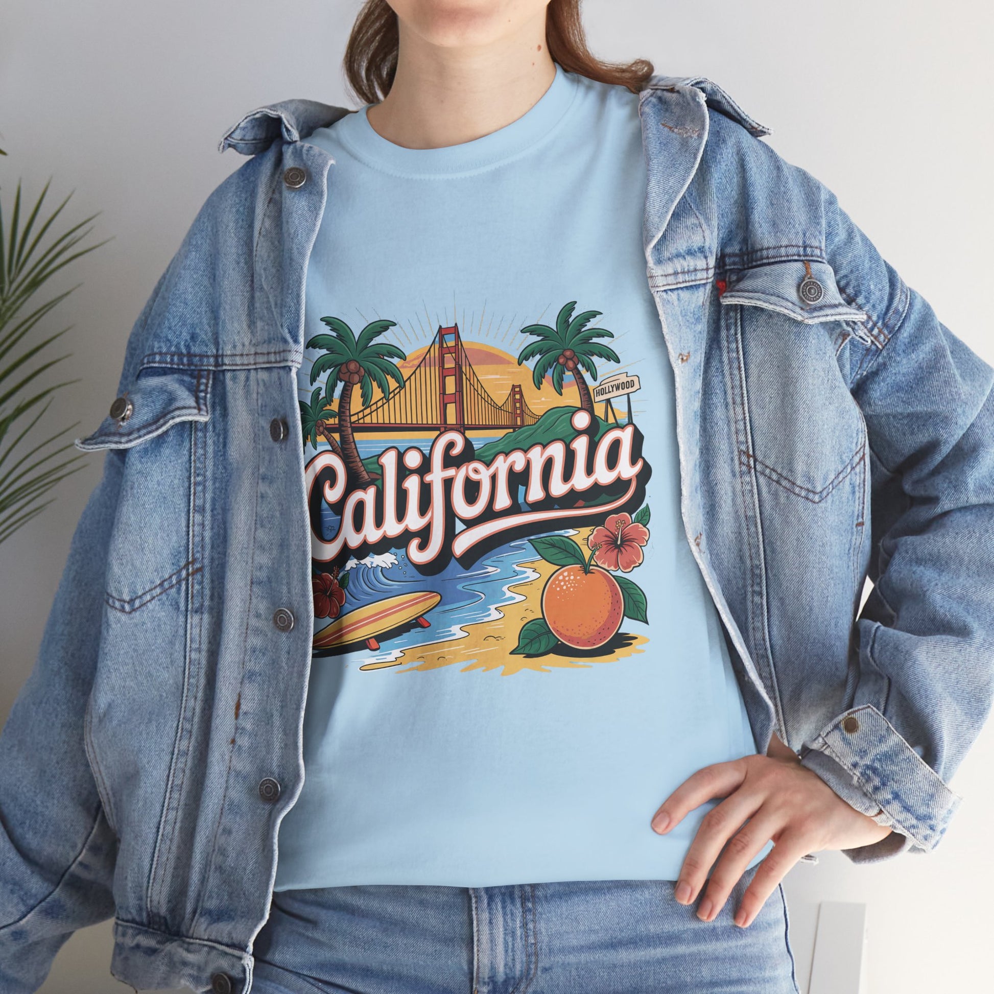 Person wearing a light blue t-shirt with 'California' graphic design, paired with a denim jacket.
