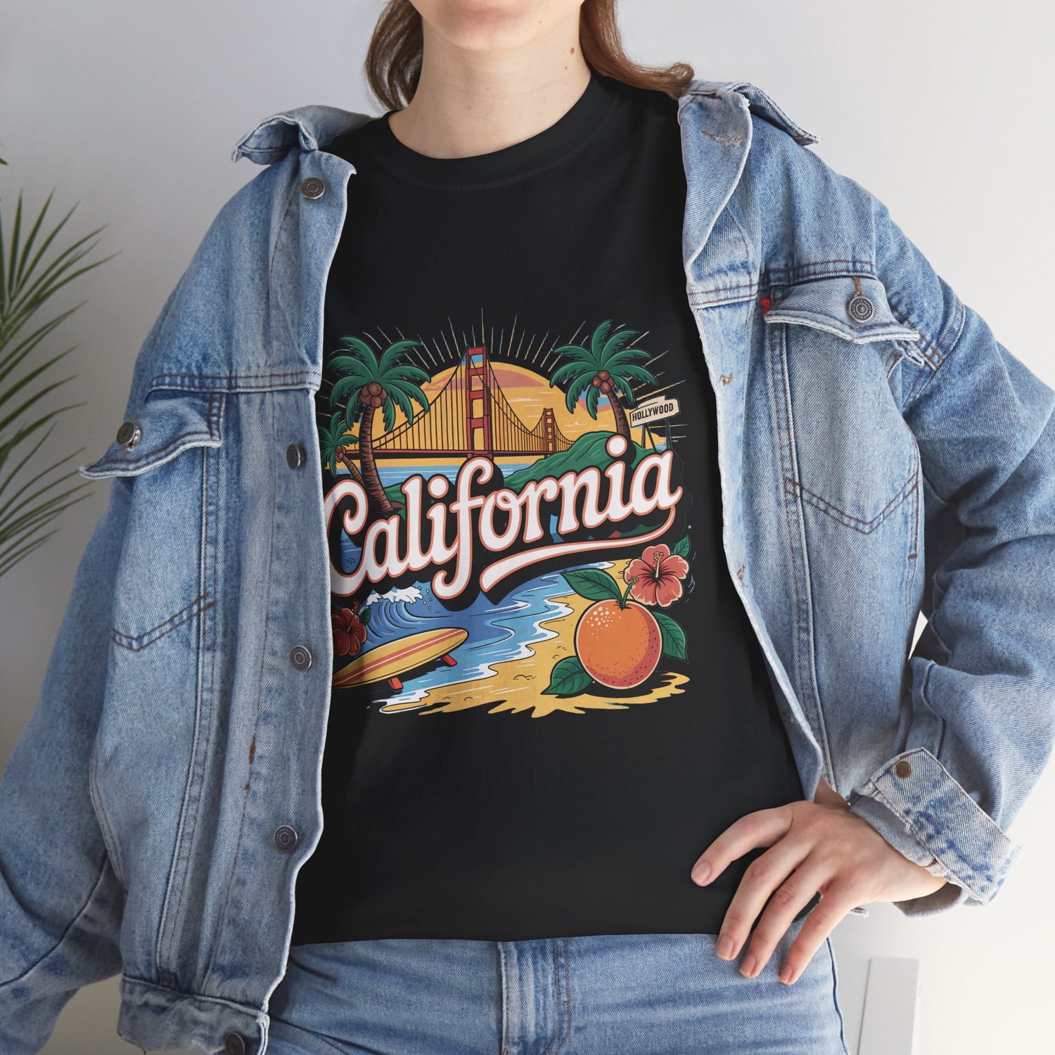 Person wearing a black t-shirt with 'California' design and denim jacket.