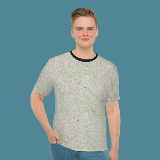 Man wearing a light gray t-shirt with a subtle pattern on a white background